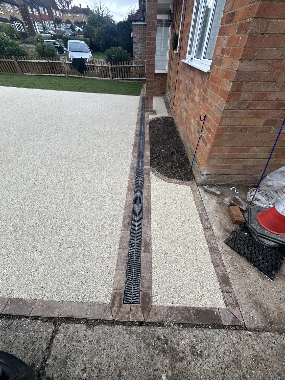 Resin bound driveway with brick edging and a linear drainage channel
